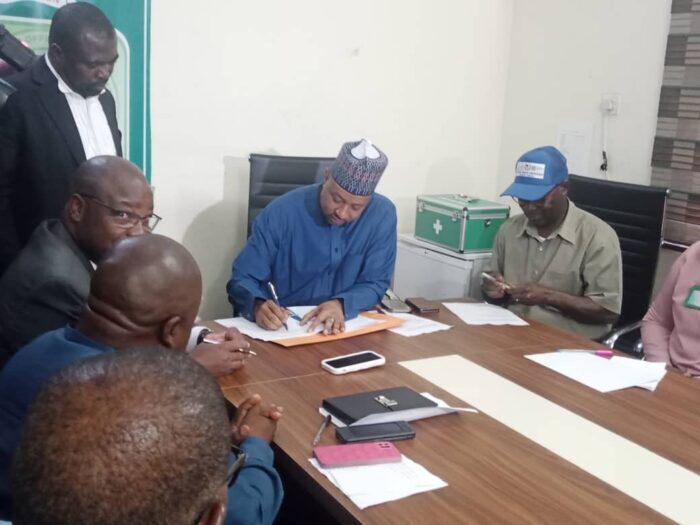 Dr Baba Yakubu Registrar, EHCON signing MoU with Mutual Benefits Assurance