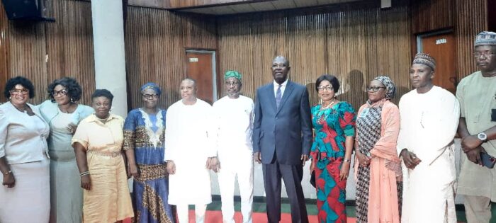 Minister of State for Petroleum Resources (Oil), Sen. Heineken Lokpobiri (5th right) and Minister of State for Petroleum Resources (Gas), Mr Ekperikpe Ekpo (6th left), in a group photograph with the Permanent Secretary, Amb. Gabriel T. Aduda and Directors of MPR, during a Town Hall Meeting