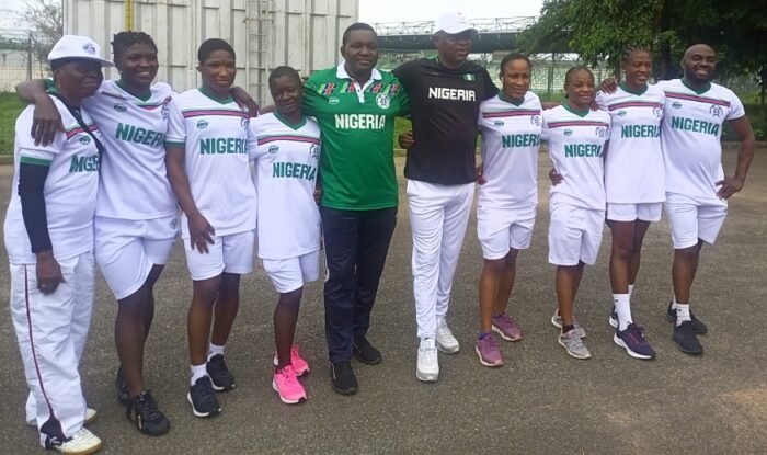 Acting Comptroller-General, Nigeria Customs Service (NCS), Mr Adewale Adeniyi (in black top) with Nigeria women wrestlers ahead of their departure for the World championships in Serbia