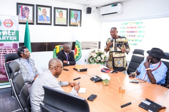 NUPRC Chief Executive Officer, Mr Gbenga Komolafe, flanked by the Executive Commissioner, Environment, Safety and Security Matters, Captain.John Tonlagha (left) and Evangelist Prince Didey (right) and Chief Ayori Emami, Warrington Community leaders during a meeting with Chevron officials at the NUPRC Hqtrs, Abuja.