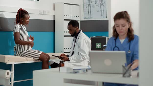 A doctor attending to a patient with a digital tool