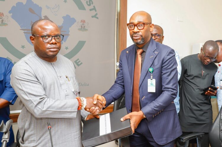 Mr Ita Henshaw, representative of outgoing Interim Administrator, Presidential Amnesty Programme (PAP), retired Maj. – Gen. Barry Ndiomu, handing over to Dr Dennis Otuaro, the newly appointed Interim Administrator