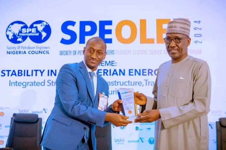 Group CEO, NNPC Ltd., Mr Mele Kyari receives a plaque in appreciation of his role as the Keynote Speaker during the 2024 edition of Society of Petroleum Engineers Oloibiri Lecture Series and Energy Forum (SPE OLEF) held in Abuja, on Thursday