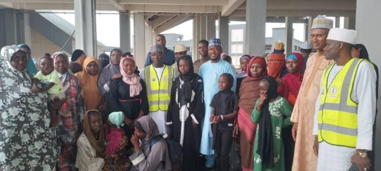The Nigerian returnees from Sudan, with the Federal Commissioner, NCFRMI, during their reception on Thursday in Abuja
