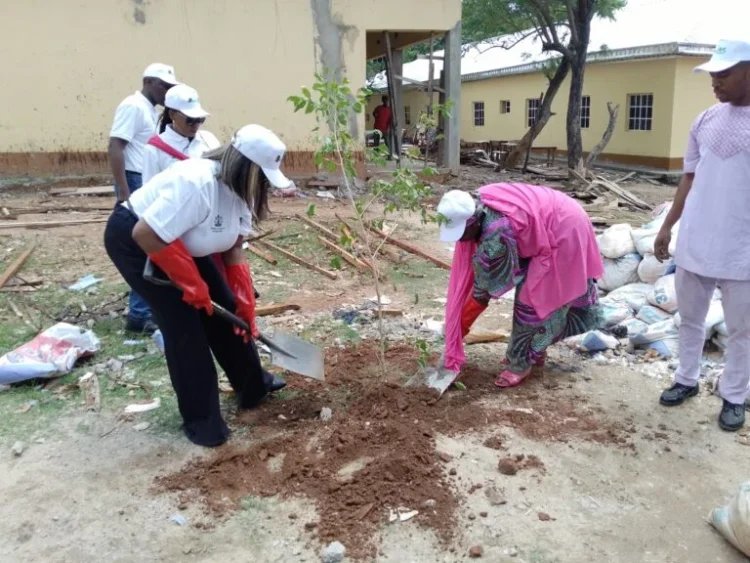 (L-R) Mrs Emmanuella Arukwe, Managing Director, NNPC Foundation Ltd. and Hajiya Jammaylah Yakubu, Principal, Government Day Secondary School Wuse 2, Abuja, planting trees in the school premises, to mark World Environment Day.