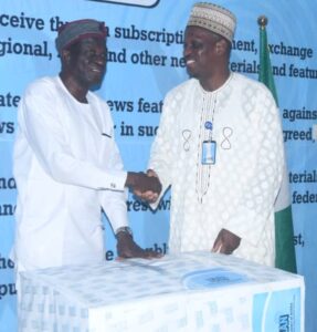 Mr Kayode Olaitan, Director, Planning, Research and Statistics (PRS), News Agency of Nigeria (NAN) (L) with the Managing Director (NAN) Ali M. Ali at at a reception held in Olaitan’s honour on Monday in Abuja