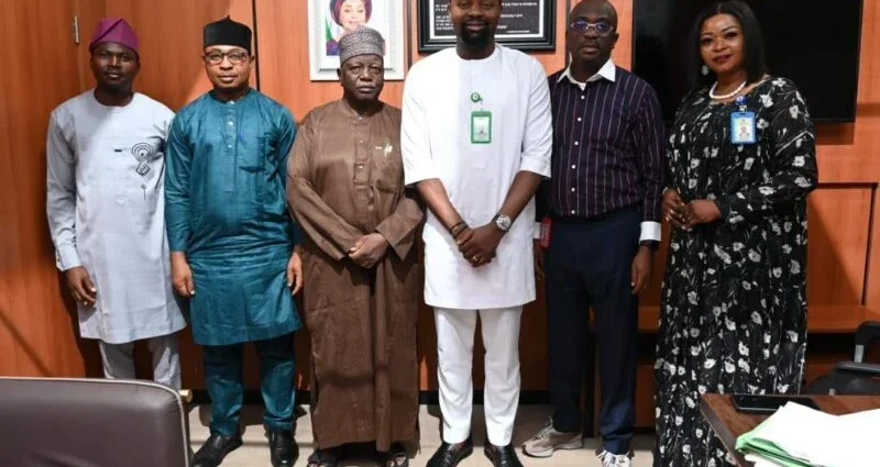 Mr Peter Eze (middle, in white), Chairman, Committee on Works, Transport and Aviation of the Federal Character Commission (FCC) with his committee members after the inauguration