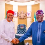 Chief Uche Nnaji, in a handshake with President Bola Tinubu