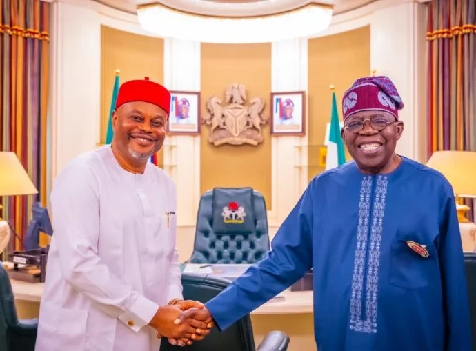Chief Uche Nnaji, in a handshake with President Bola Tinubu