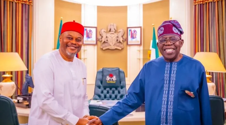 Chief Uche Nnaji, in a handshake with President Bola Tinubu