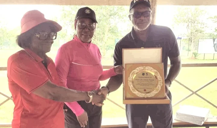 LGAN President, Lami Ahmed presenting an award of appreciation to Chief Emeka Mamah, the Chief Executive Officer of Ifesinachi during an AACT sensitisation visit at the Enugu Golf Club on Monday. (PhotoCredit:NAN)