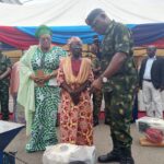Nigerian Legion National Chairman, Ms Grace Henry (1st Left) with a beneficiary  and others at the empowerment programme and induction of ex-servicemen into the Institute of Disaster Management and Safety Sciences (IDMSS) on Monday in Abuja 