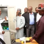 Head of the University clinic, Dr Hassan Mohammed, showing NOUN VC, Prof. Uduma Uduma and other management staff some of the equipment at the facility.