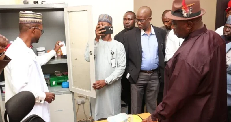Head of the University clinic, Dr Hassan Mohammed, showing NOUN VC, Prof. Uduma Uduma and other management staff some of the equipment at the facility.