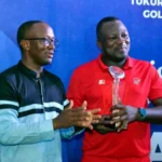 Brig. Gen. Nicholas Ashinze, the Captain of TYB International Golf Resort and Country Club (TYB-IGRCC) applauding Abiola Popoola, the overall winner of the just concluded Captain’s Inaugural Golf Tournament, as he lifts his trophy.(PhotoCredit:NAN)