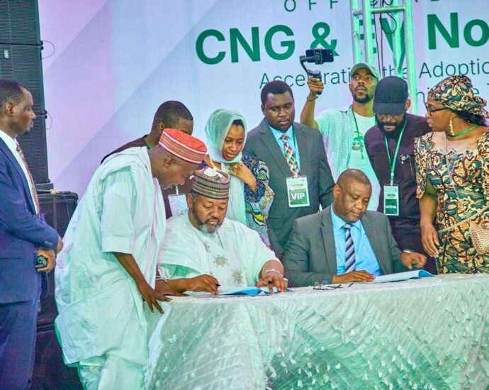 Seated L-R: Barrister Ismael Ahmed, Executive Chairman, Presidential Compressed Natural Gas Initiative (PCNGI); and Mr. Nazif Ibrahim, Regional Head Northeast and Northwest, LOTUS Bank; signing the PCNGI partnership agreement while other dignitaries watch in Kano, Kano State