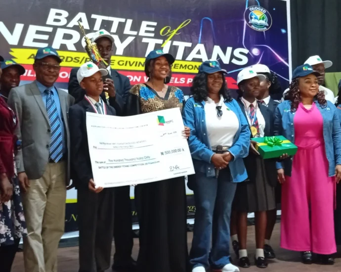Mrs Emmanuella Arukwe, Managing Director, NNPC Foundation Ltd. (3rd right), with Mr Chris Akinsowon, Principal, Premier Academy, (2nd left) and other officials and students at the “Battle of Energy Titans Award/Prize Giving Ceremony” on Tuesday in Abuja.
