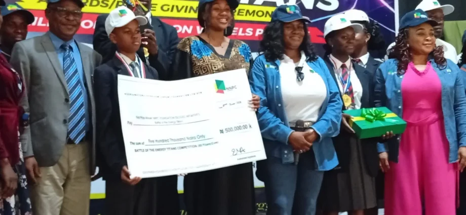 Mrs Emmanuella Arukwe, Managing Director, NNPC Foundation Ltd. (3rd right), with Mr Chris Akinsowon, Principal, Premier Academy, (2nd left) and other officials and students at the “Battle of Energy Titans Award/Prize Giving Ceremony” on Tuesday in Abuja.