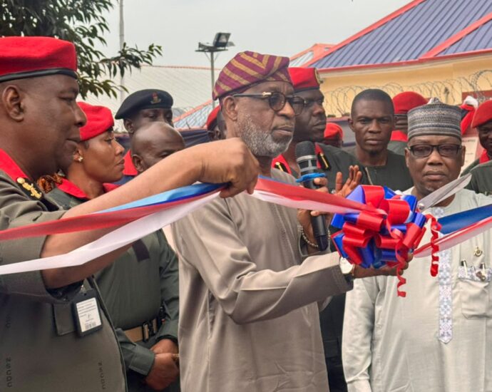 The Minister of Solid Minerals, Dr Dele Alake with others at the inauguration of eight new gun trucks on Wednesday at the NSCDC Headquarters.