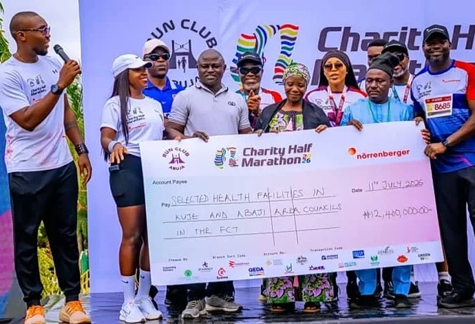 Organisers of the Run Club Abuja Charity Half Marathon presenting the cheque to the selected hospitals in FCT