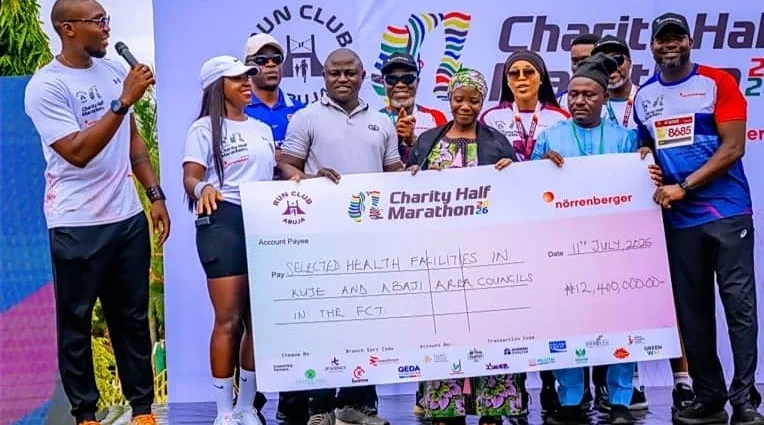 Organisers of the Run Club Abuja Charity Half Marathon presenting the cheque to the selected hospitals in FCT