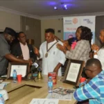 Outgoing president of Rotary Club of Abuja, The Ambassadors, Nelly Williams, handing over the symbol of leadership to Prince Herberts, at a ceremony in Abuja.(PhotoCredit:NAN)