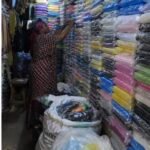 Rain gear seller in a Lagos market