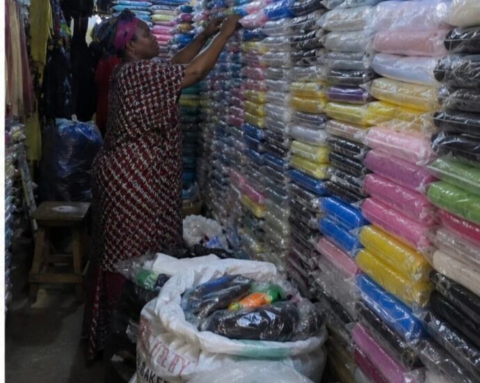 Rain gear seller in a Lagos market