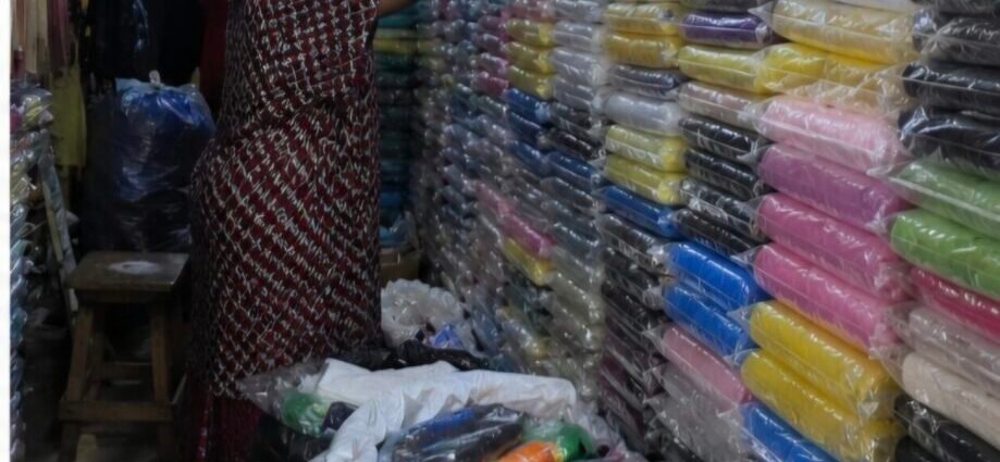 Rain gear seller in a Lagos market