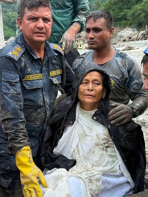 Nepal Police and Armed Police Force (APF) members rescued Chandika Kumari Shrestha, victim of the deadly flash floods and mudslides, in Betrawati, Nuwakot District, Nepal,