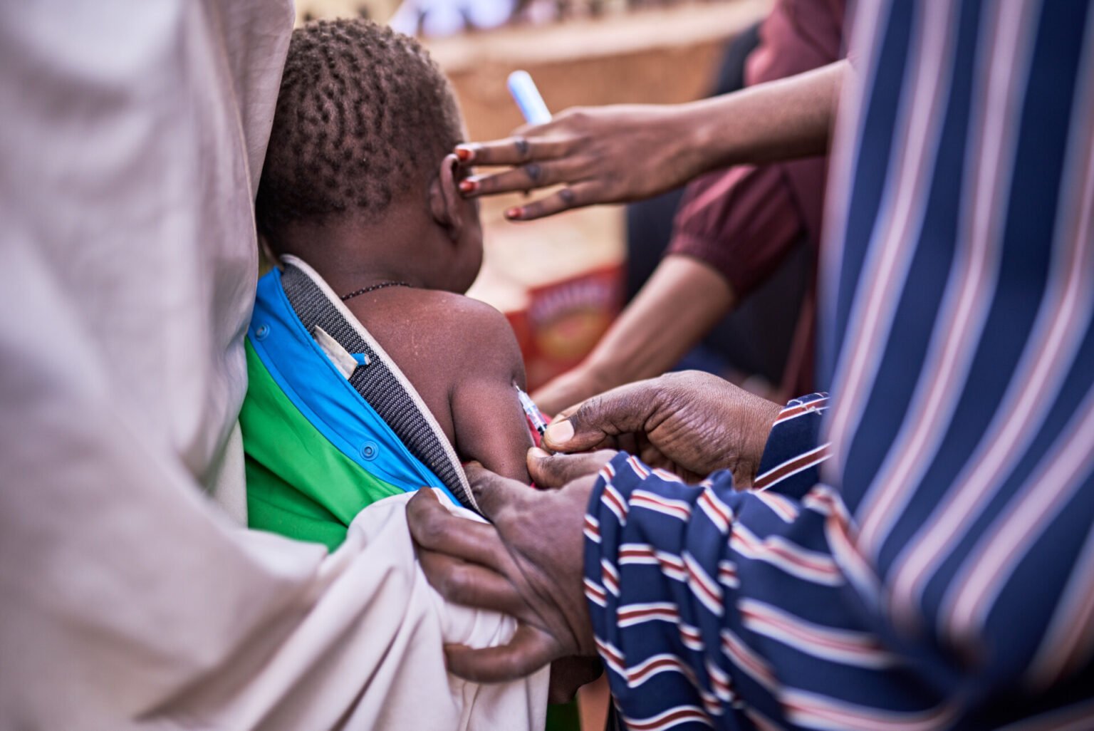a child receiving a vaccination from a healthcare professional vector