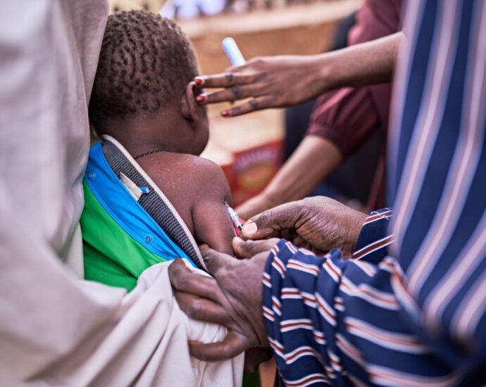 a child receiving a vaccination from a healthcare professional vector