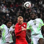 Players of the Super Eagles slugging it out with a Russian player