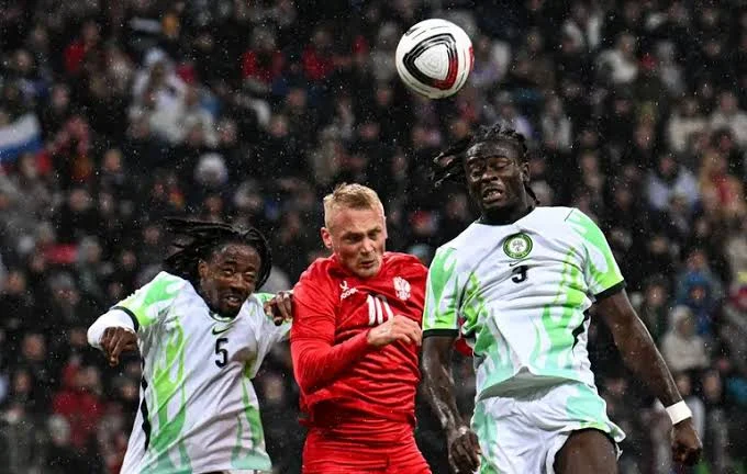 Players of the Super Eagles slugging it out with a Russian player